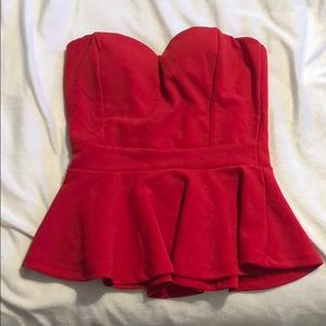 Never worn. Red strapless, flare top.